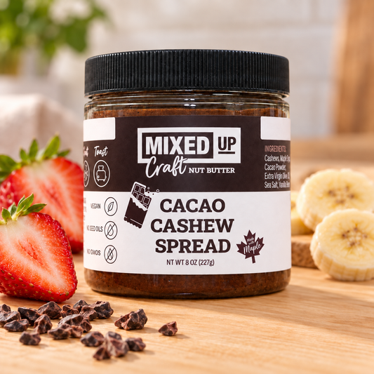 Creamy cacao cashew nut butter from Mixed Up Foods in an 8 oz jar, shown with spread on bread and a glass of milk.