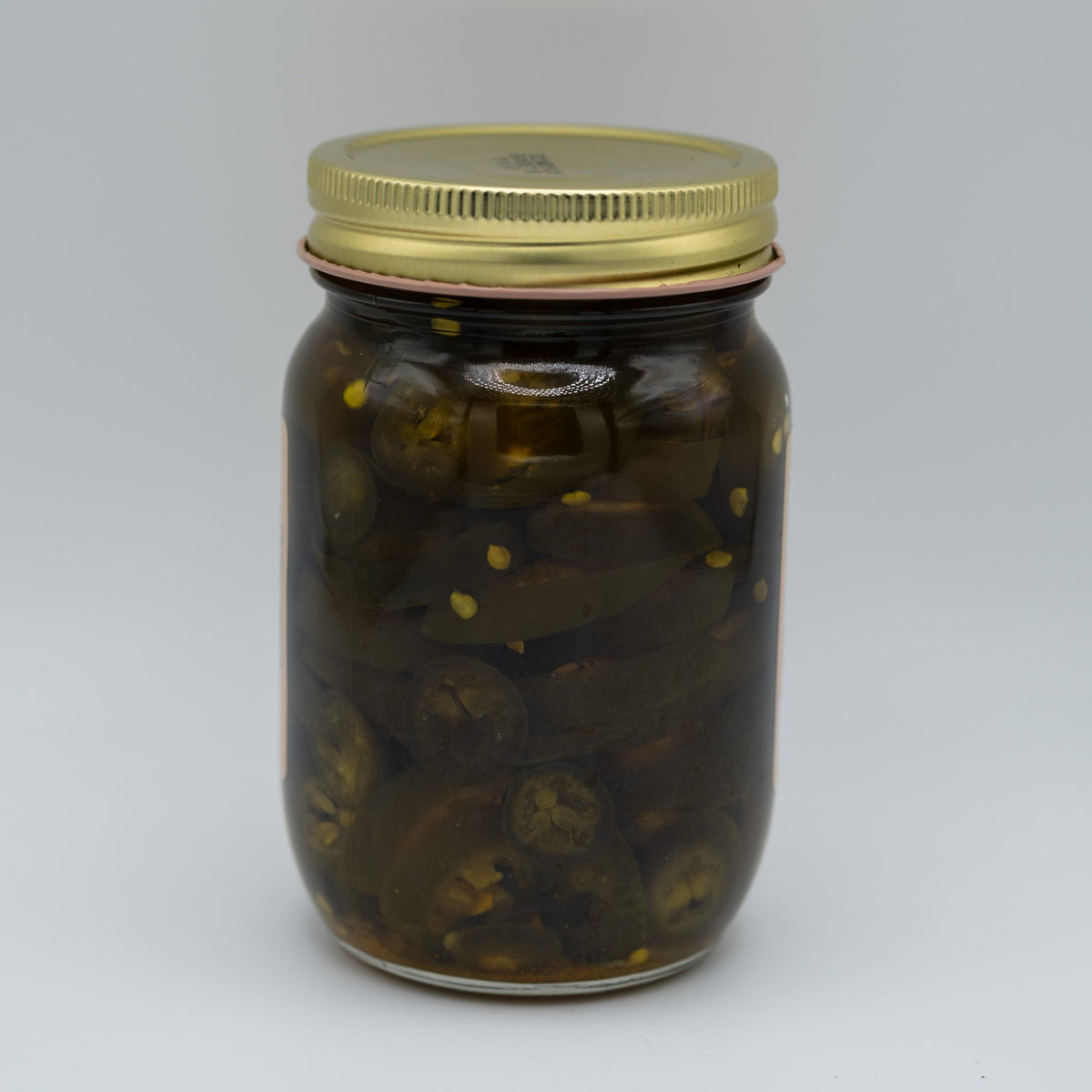 Canned candied jalapenos in a 16 oz jar from Amish Country Store, showcasing glossy, sweet-spicy jalapenos in syrup.