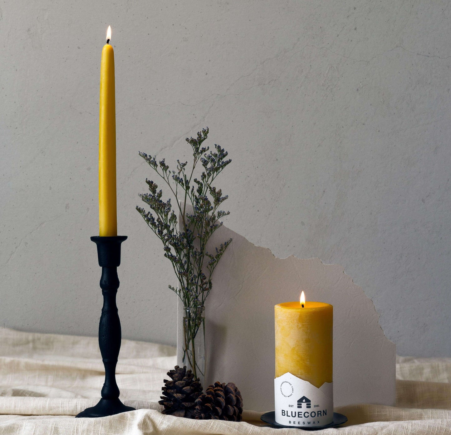 Pair of handcrafted cast iron taper candle holders by Bluecorn Candles, featuring a rustic, durable design for elegant candle display.