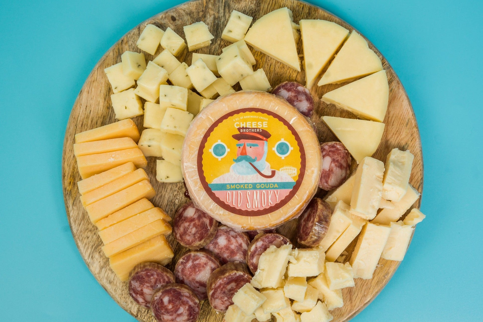 Cheese Brothers Inc. Charcuterie Box with assorted cured meats, cheeses, and crackers in a wooden gift bundle.