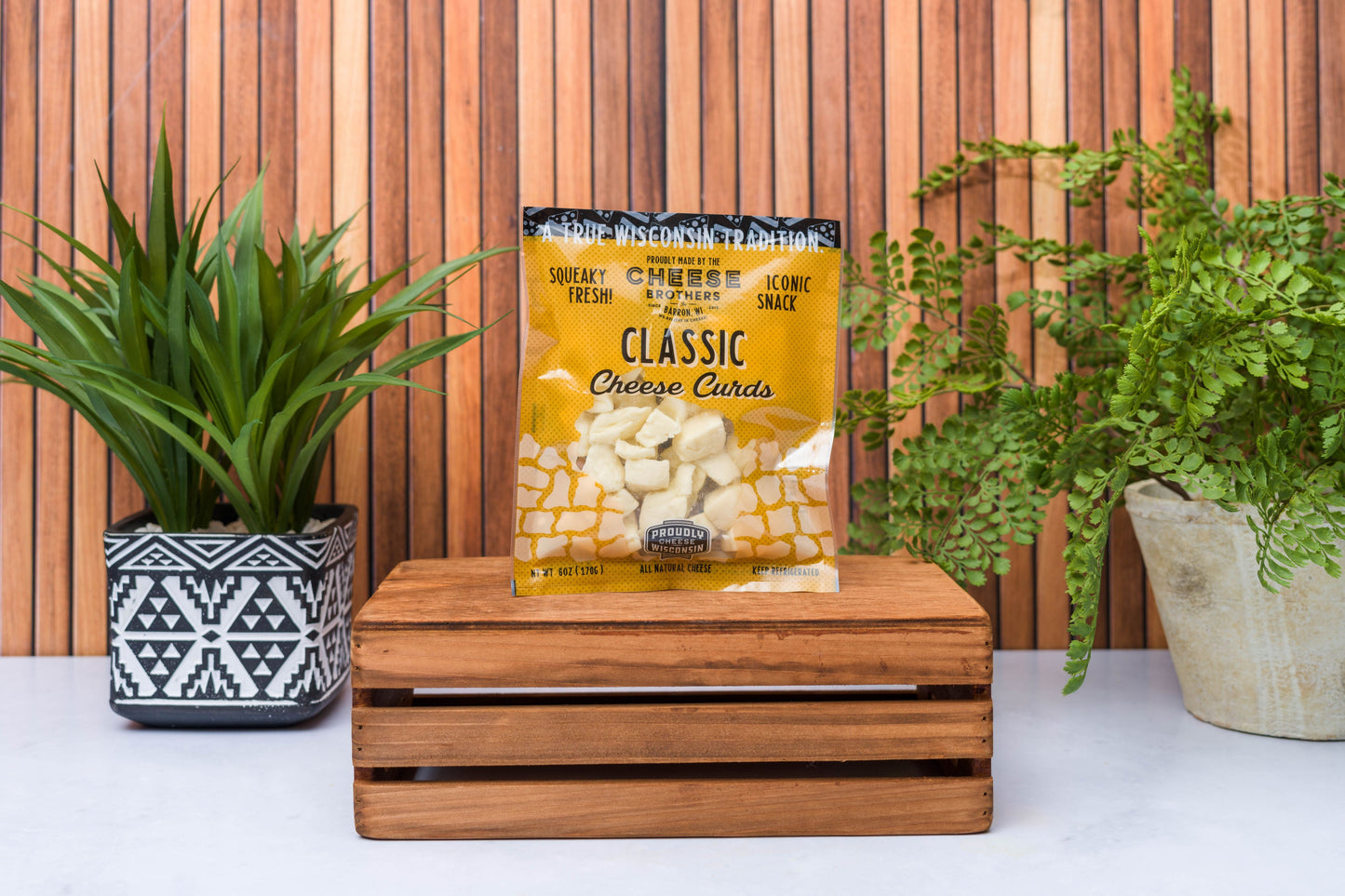 Assorted Wisconsin cheese curds sampler from Cheese Brothers, Inc., featuring eight fresh, golden cheese curds in a gift bundle.