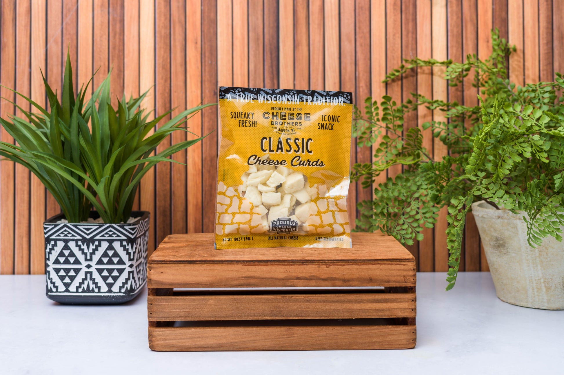 Assorted Wisconsin cheese curds sampler from Cheese Brothers, Inc., featuring eight fresh, golden cheese curds in a gift bundle.