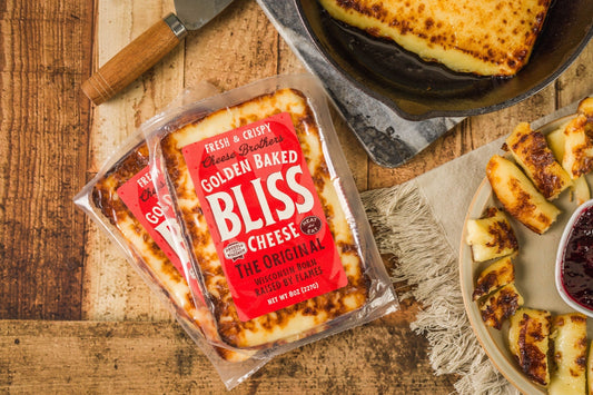 Golden Baked Bliss Cheese from Cheese Brothers, Inc., baked cheese pack with a golden, crispy crust and melted cheese interior.
