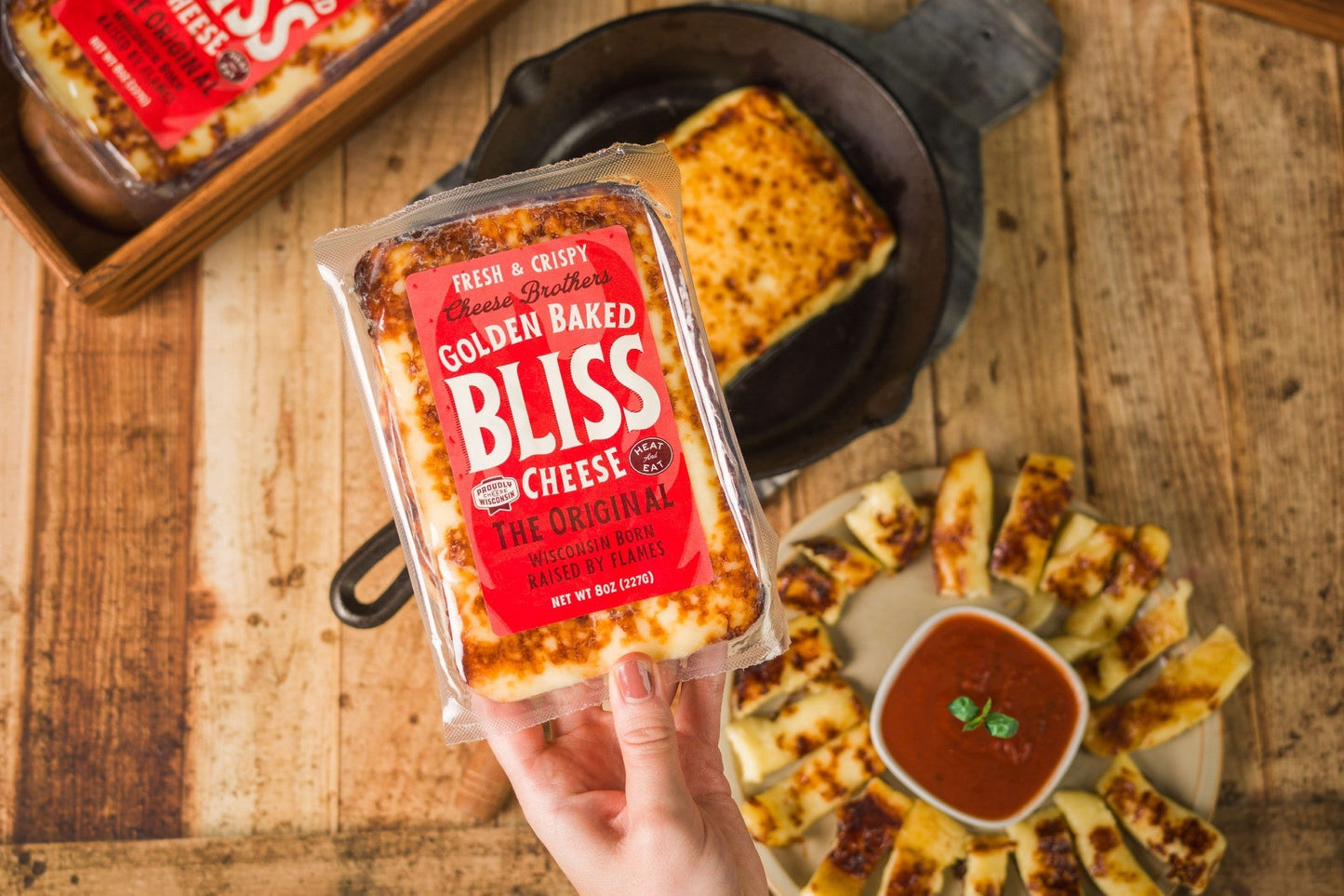 Golden Baked Bliss Cheese from Cheese Brothers, Inc., a baked cheese pack shown with golden, crispy cheese slices.