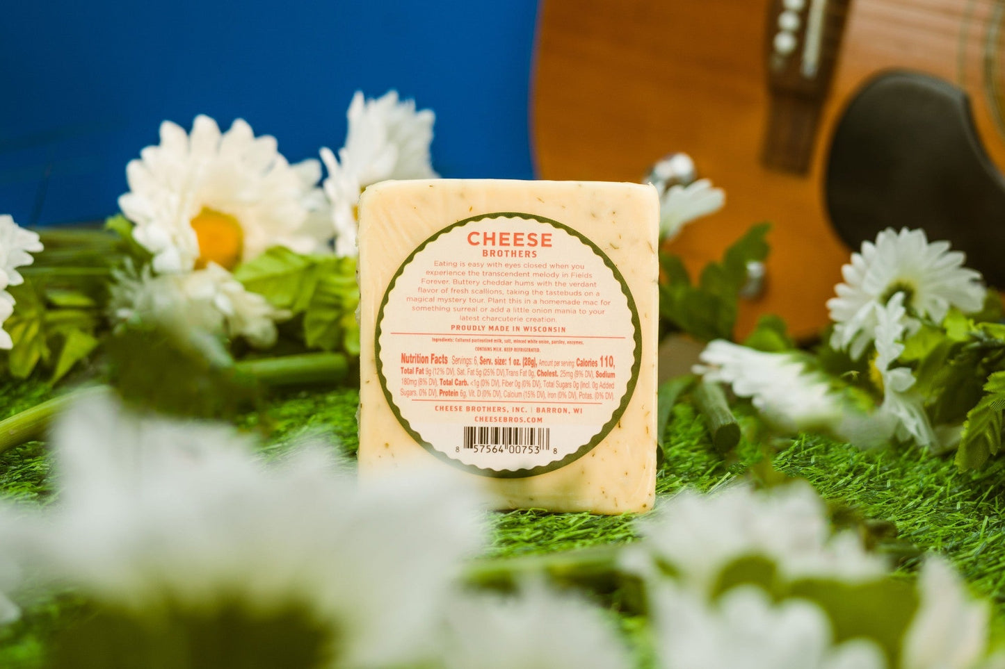 Slices of Cheese Brothers Inc. Fields Forever Green Onion Cheddar cheese showing creamy texture and green onion bits.