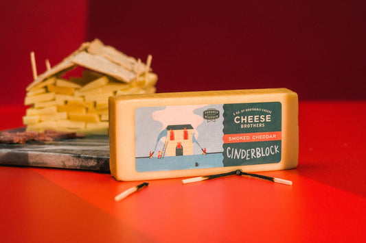 Smoked cheddar cheese by Cheese Brothers, Inc., showing a block of rich, golden smoked cheddar with a smooth texture.