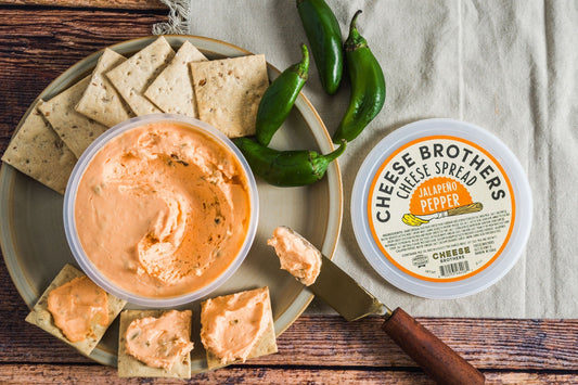 Creamy jalapeño pepper cheese spread by Cheese Brothers, Inc., showcasing a smooth, spicy cheese spread in a jar.