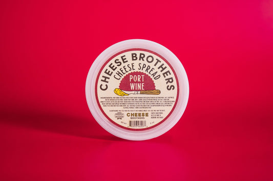 Port wine cheese spread by Cheese Brothers, Inc., creamy cheese spread infused with port wine flavor in a jar.