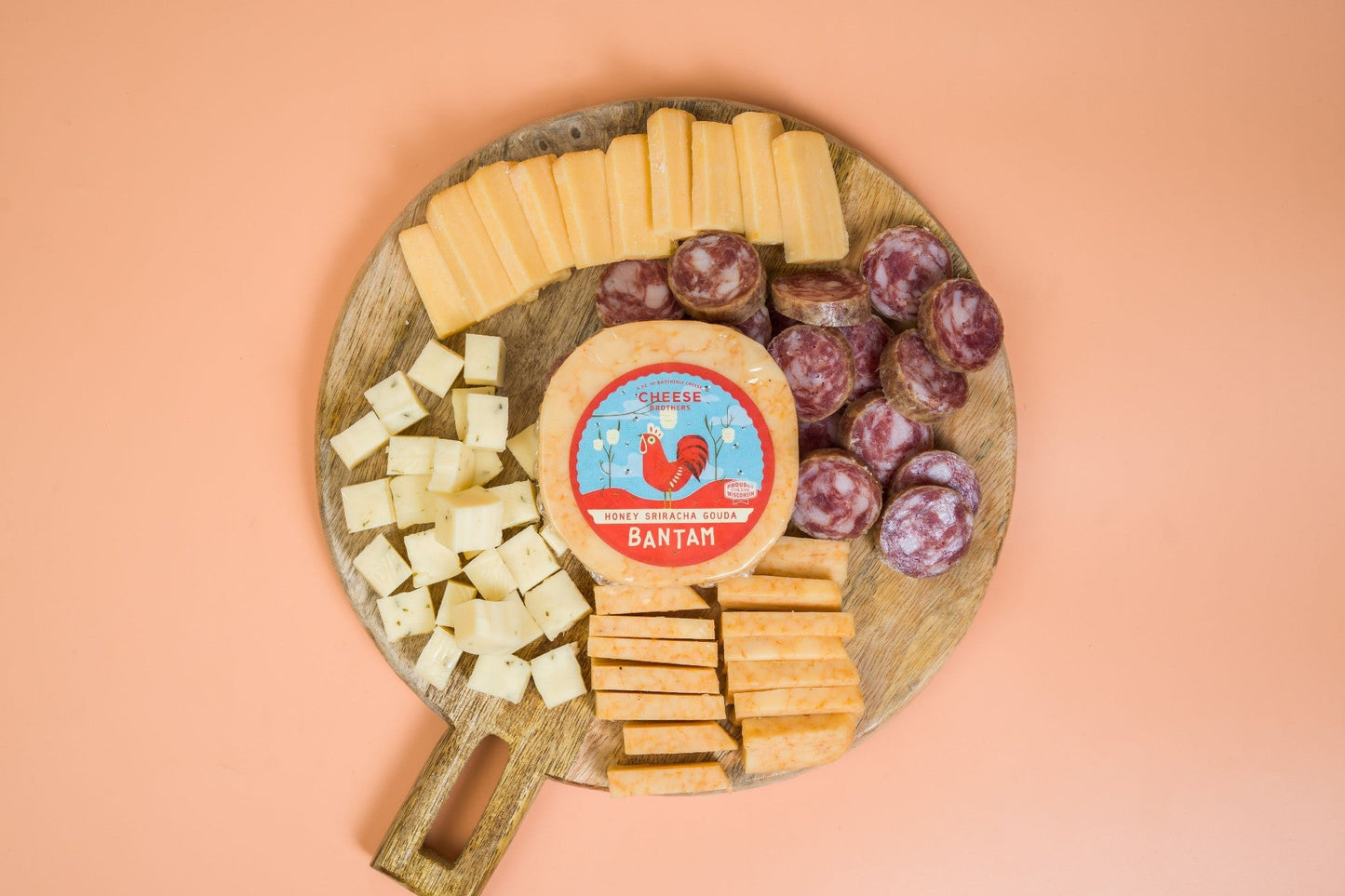 Cheese Brothers, Inc. cheese and sausage sampler 4-pack featuring assorted cheeses and cured sausages in gift bundle.