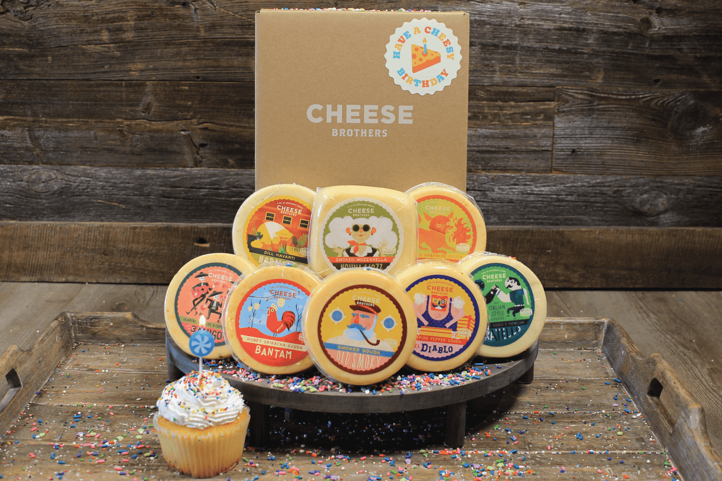 Cheese Brothers Inc. "Have a Cheesy Birthday" gift basket with assorted cheeses and snacks for celebration.