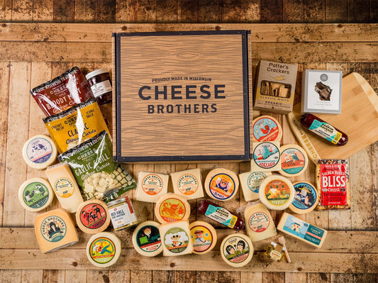 Assorted gift and bundle box from Cheese Brothers, Inc. featuring a variety of cheeses and snacks in a decorative package.