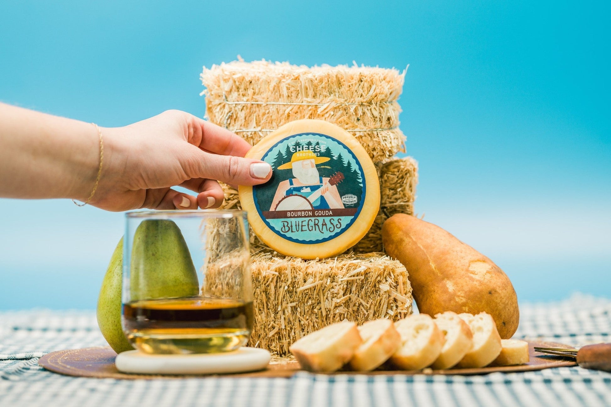 Bluegrass Bourbon Gouda cheese by Cheese Brothers, Inc. featuring a creamy, golden cheese block with bourbon infusion