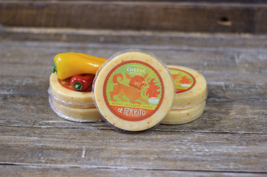 Mango Habanero Gouda cheese block from Cheese Brothers, Inc., showcasing vibrant mango and habanero pepper flavoring