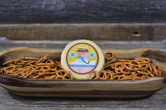 Smoked Gouda cheese by Cheese Brothers, Inc., showcasing creamy, smoked Gouda cheese with a smooth texture and rich flavor.