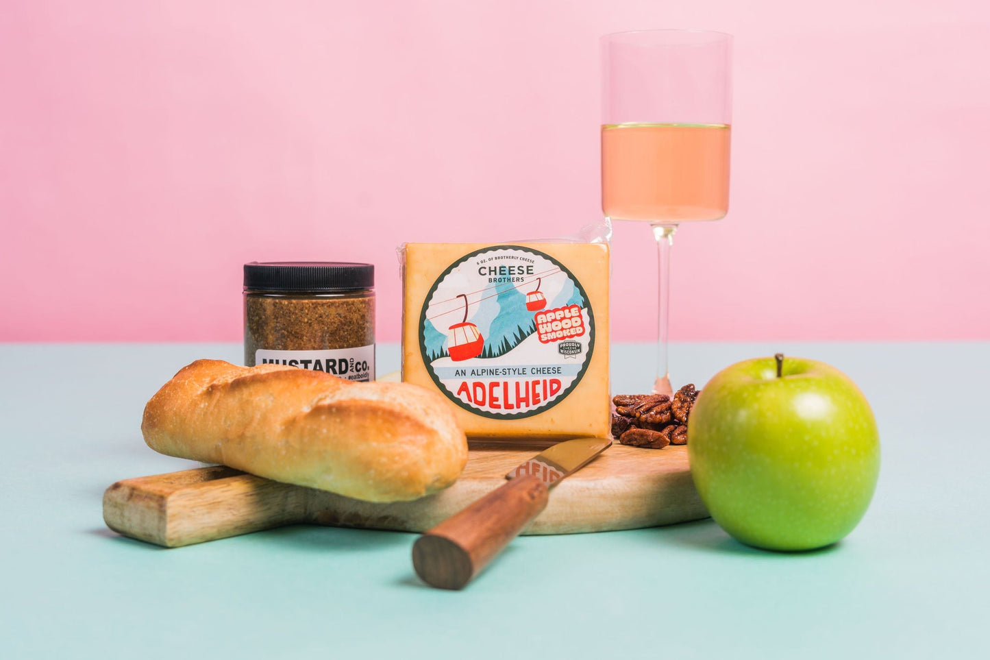 Smoked Adelheid Alpine-Style Cheese by Cheese Brothers, Inc., showing a wedge of original cheese with a textured rind and creamy interior.