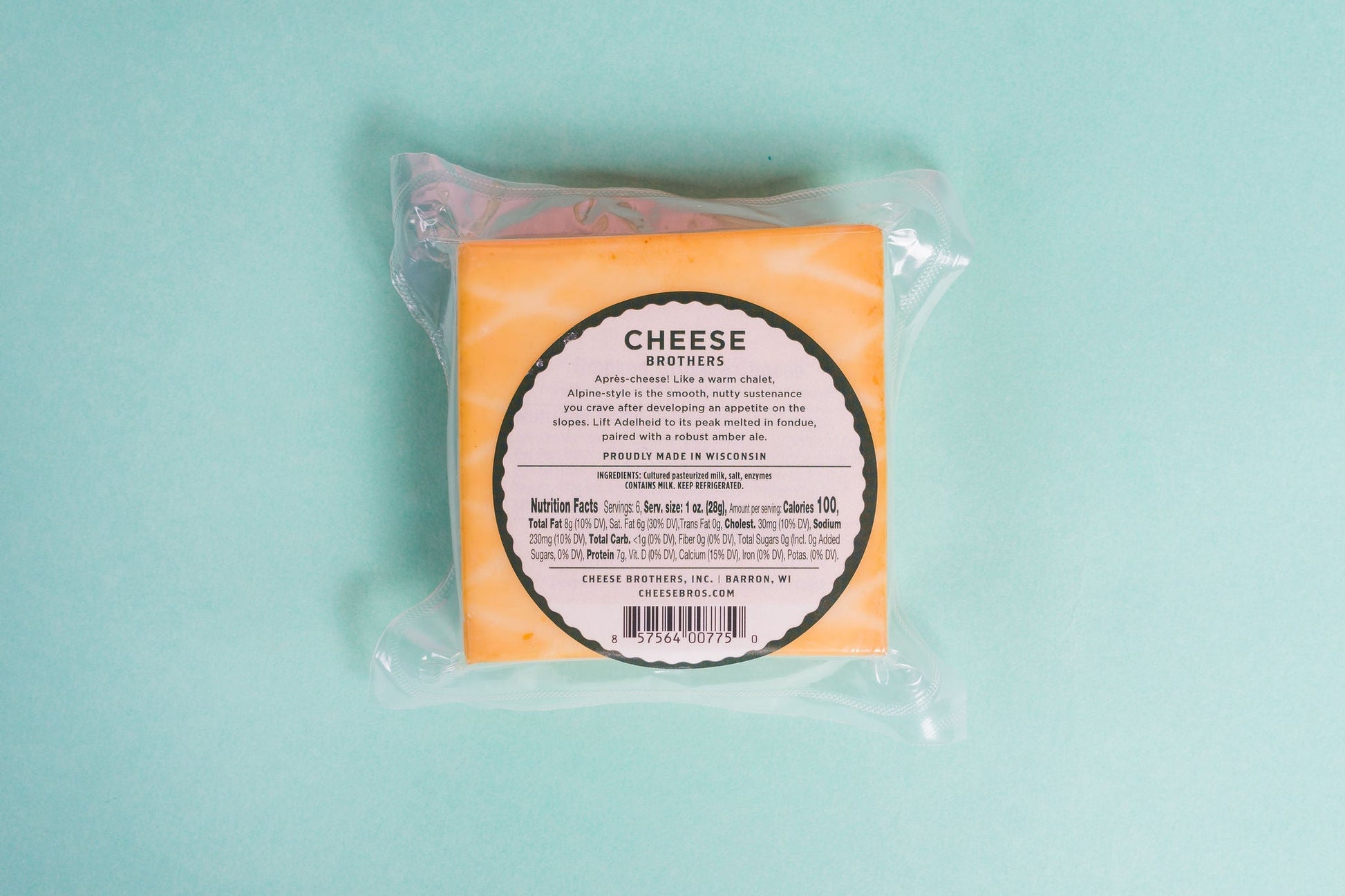 Smoked Adelheid Alpine-Style Cheese from Cheese Brothers, Inc., showcasing a wedge of creamy, textured cheese with a smoked rind.