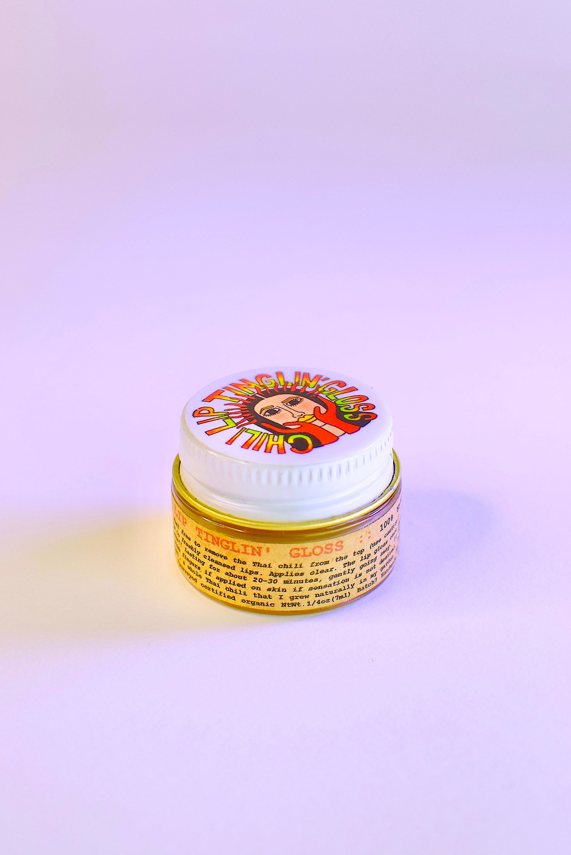 Plant Makeup Chili Lip Tinglin' Gloss applied on lips, showcasing its glossy finish and tingling effect in a close-up view.