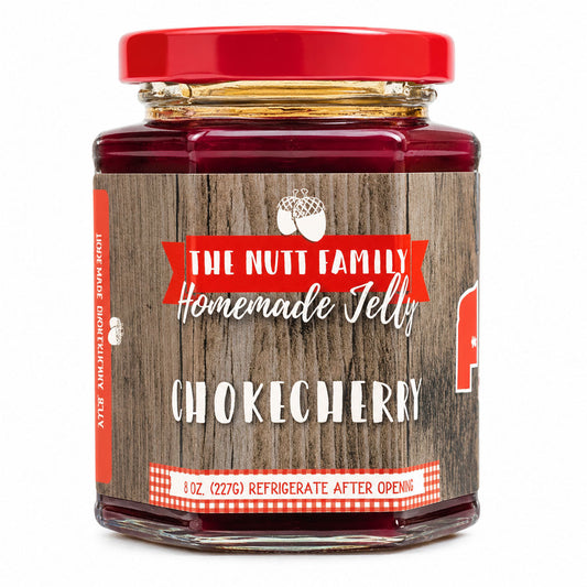 Jar of Nutt Family Jams chokecherry jelly, 9 oz, with a dark red color and label showing chokecherry fruit and brand name.