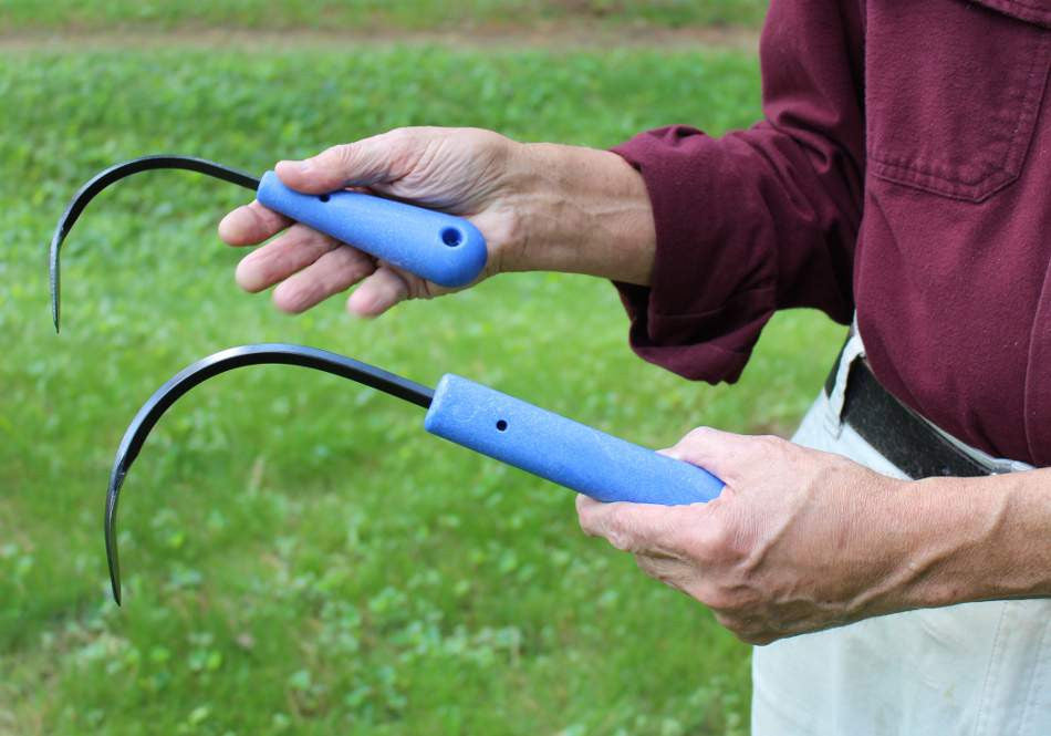 CobraHead Mini Weeder and Cultivator garden tool with ergonomic handle and metal tines for weeding and cultivating soil.