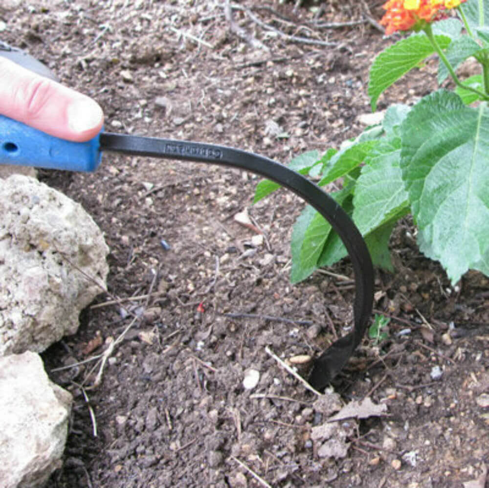 CobraHead Original Weeder and Cultivator Garden Tool with ergonomic handle and sharp metal tines for garden weeding and cultivation.