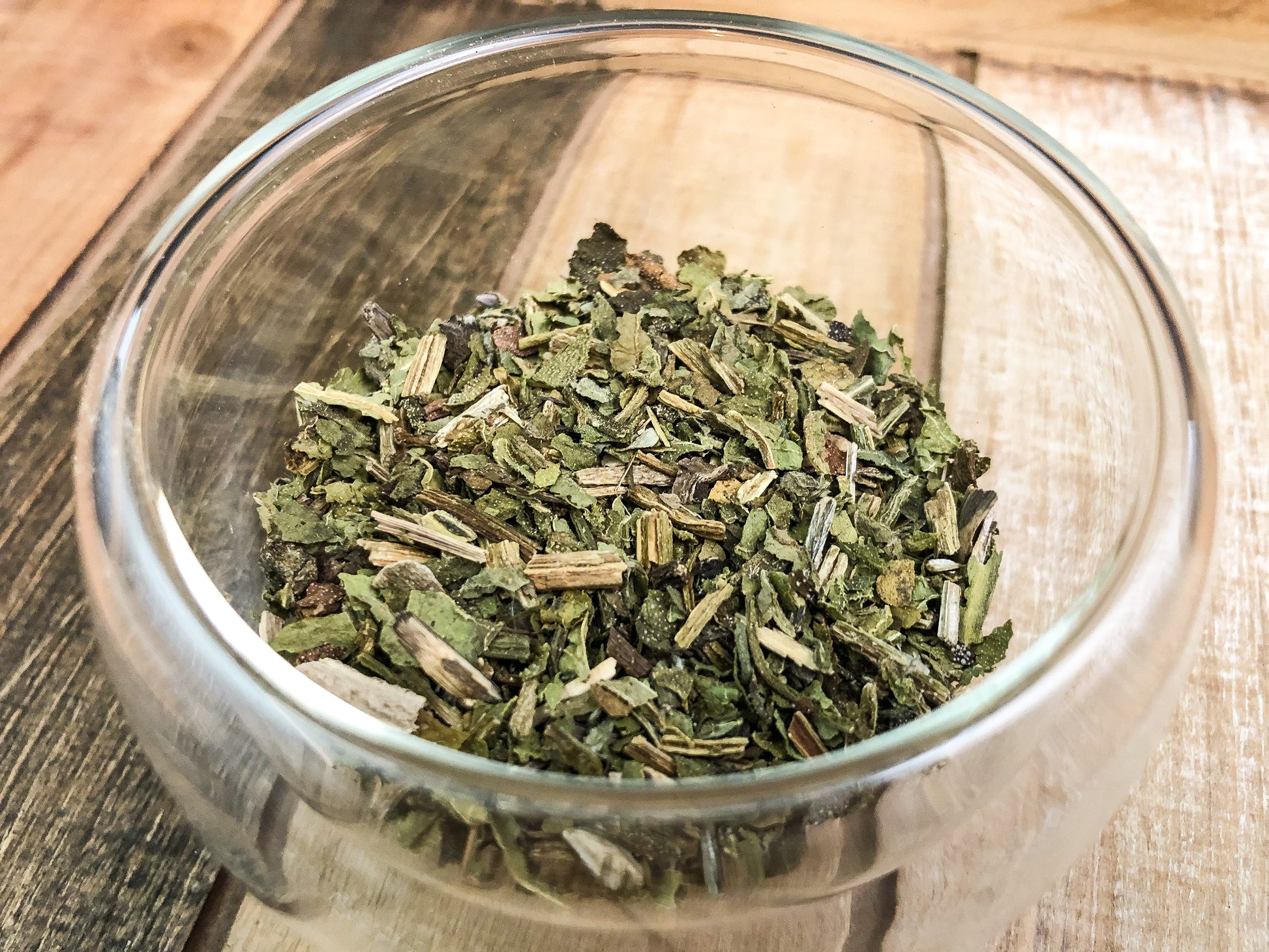 Dried comfrey herbs from HerbalRoseApothecary, showcasing leafy, green comfrey leaves on a natural background.