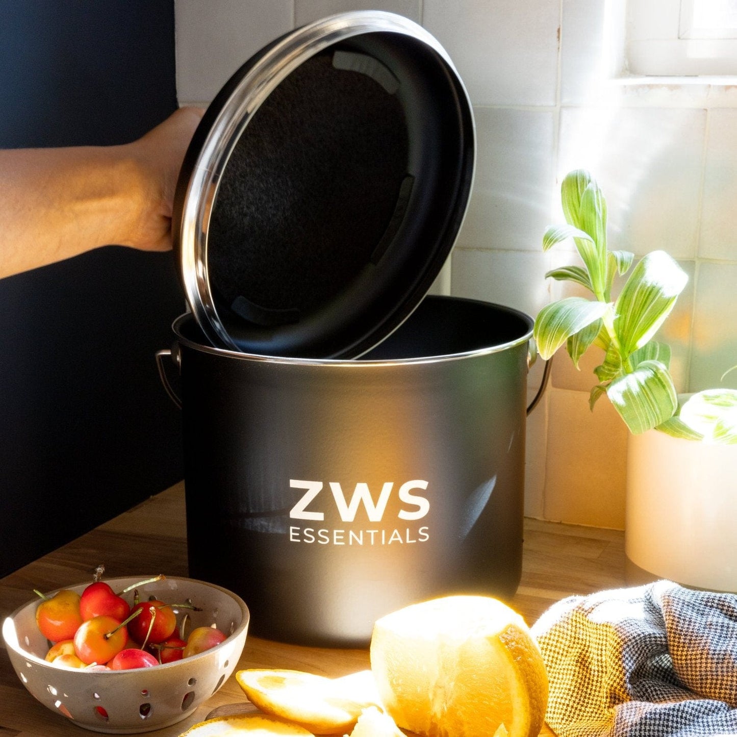Black countertop compost bin from ZeroWasteStore.com, compact kitchen compost container with lid for easy waste collection.