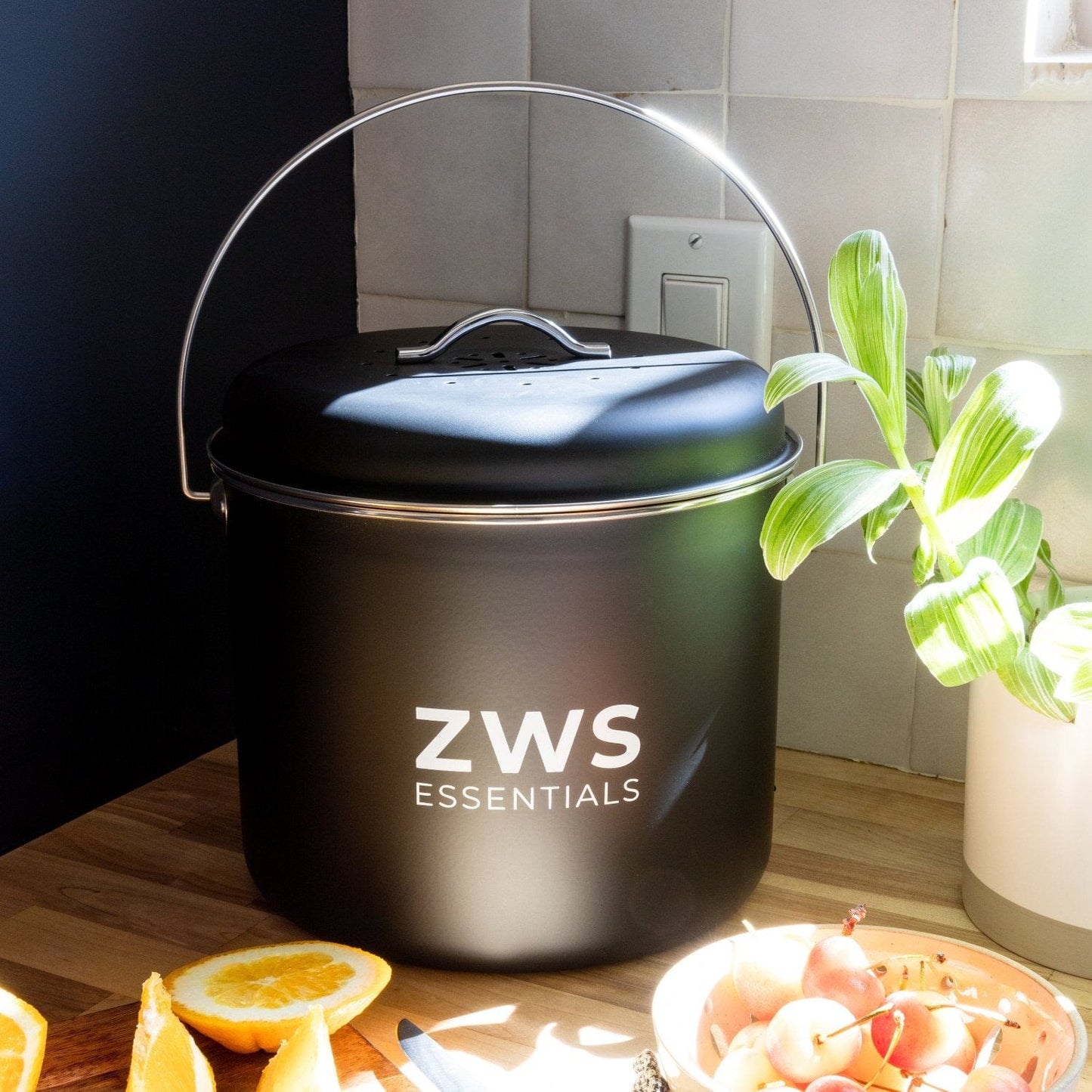 Black countertop compost bin kit from ZeroWasteStore.com, featuring a compact kitchen compost container with a lid for easy waste collection.