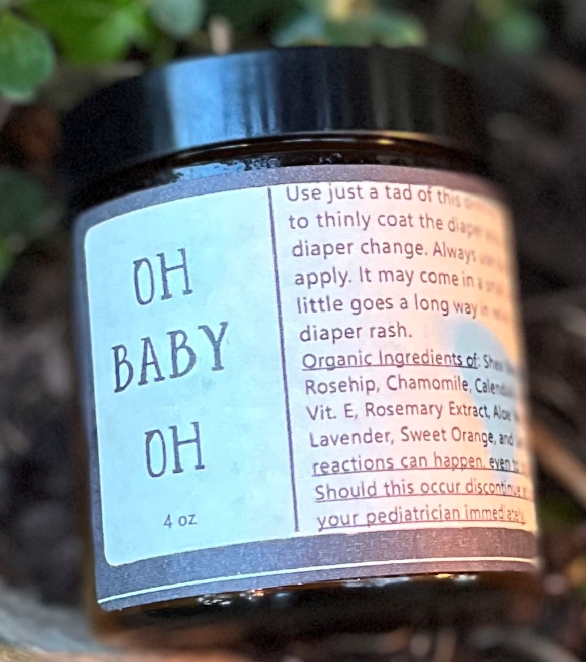 Sweet Harvest Farms Oh Baby Oh! "What a Bum!" organic diaper balm jar, showing the label for chafing and cracked skin relief.