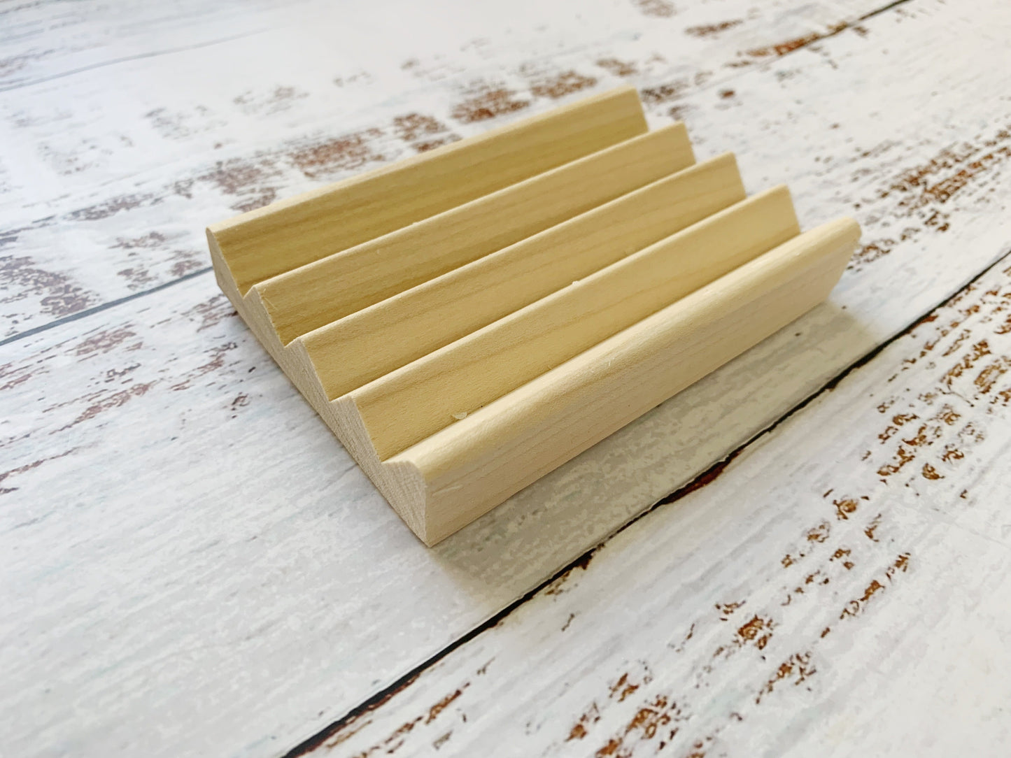 Set of two wooden soap dishes from Dot and Army, natural bamboo cleaning tools with slotted design for soap drainage.