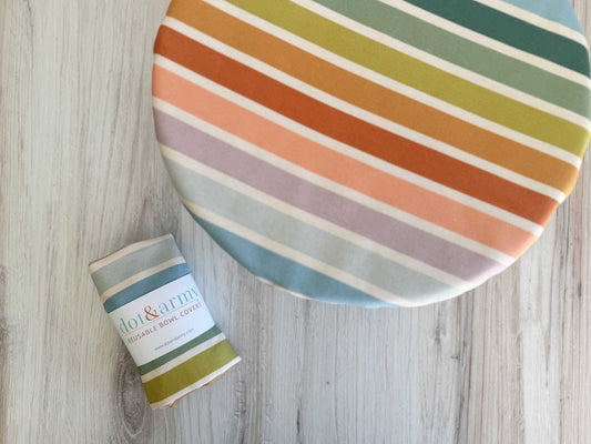 Reusable bowl cover with beach chair stripe pattern by Dot and Army, protects food containers with colorful, striped design.