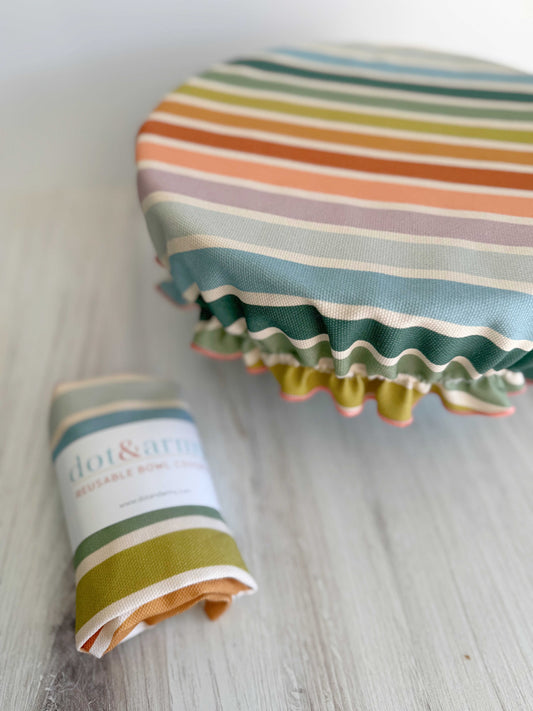 Reusable bowl cover with beach chair stripes by Dot and Army, designed for food containers, featuring a colorful striped pattern.