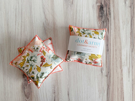 Set of two coral and blue lavender sachets by Dot and Army, decorative household cleaning supplies for freshening spaces.
