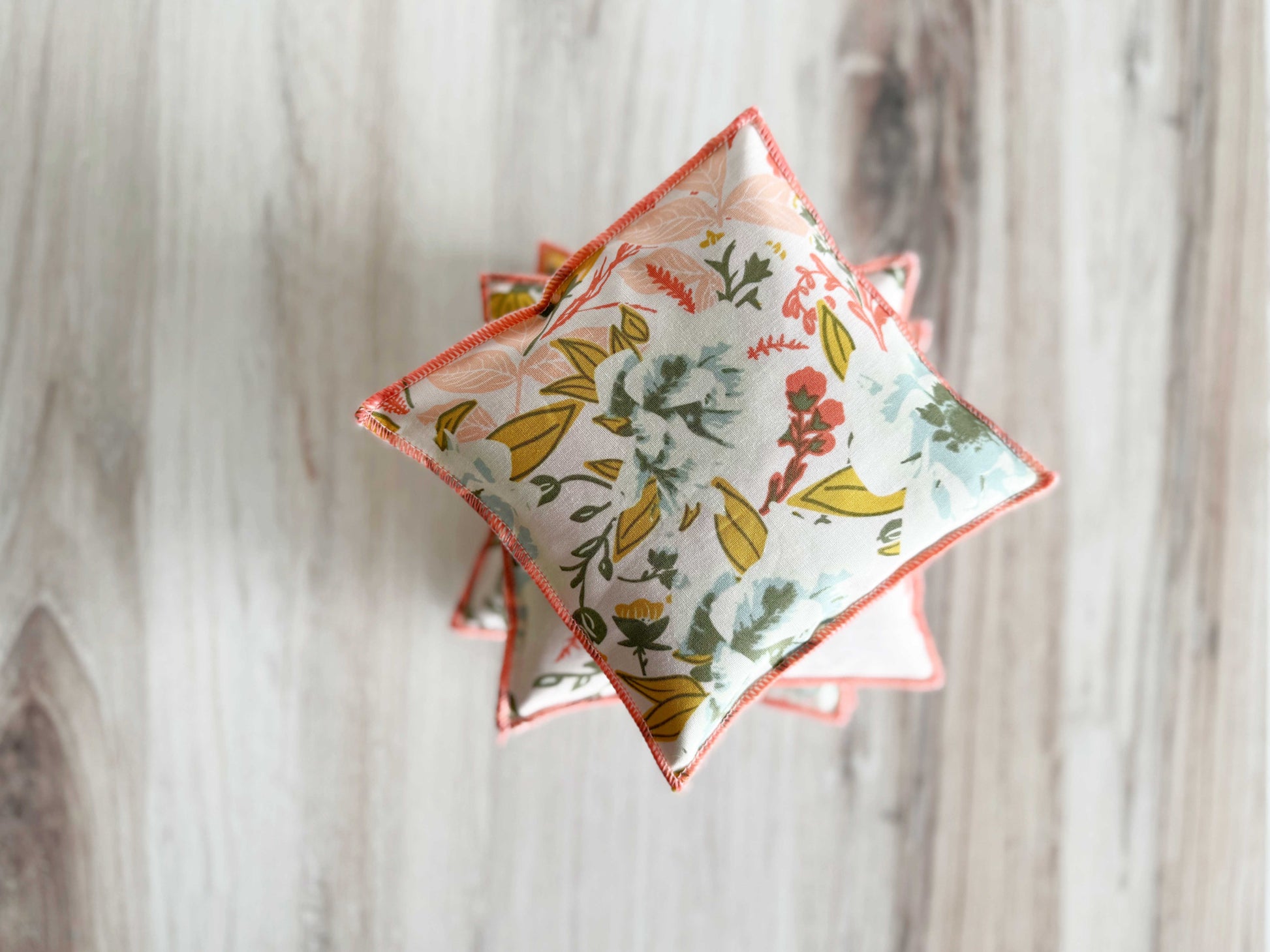 Set of two coral and blue lavender sachets by Dot and Army, decorative household cleaning supplies for freshening spaces.