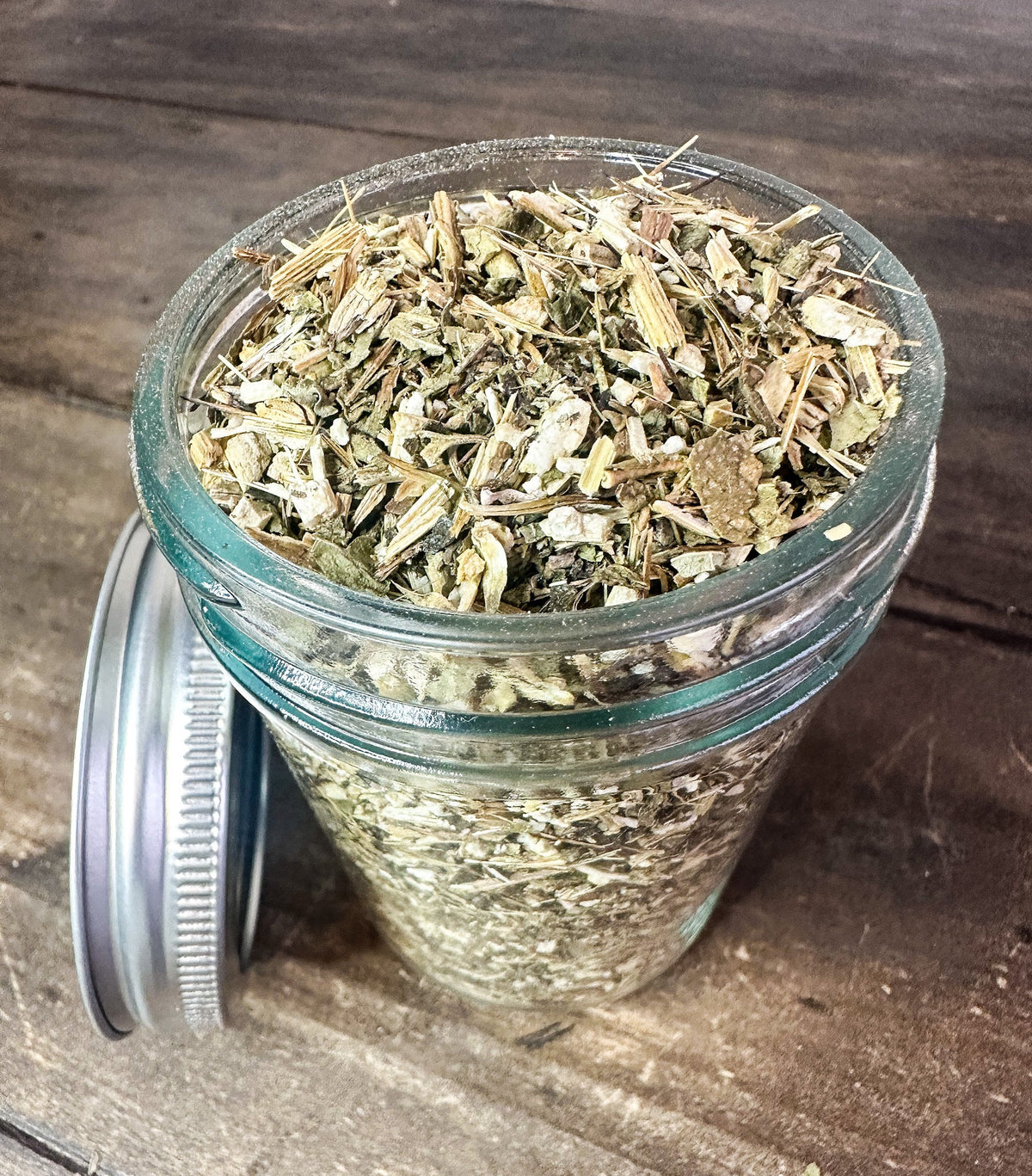 Small jar of dried echinacea herbs from HerbalRoseApothecary, featuring a clear label and a silver lid on a white background.