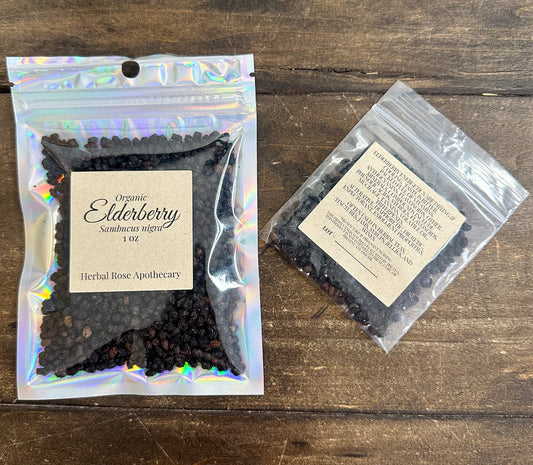 Dried organic elderberries from HerbalRoseApothecary, close-up of small dark purple berries used for herbal remedies.