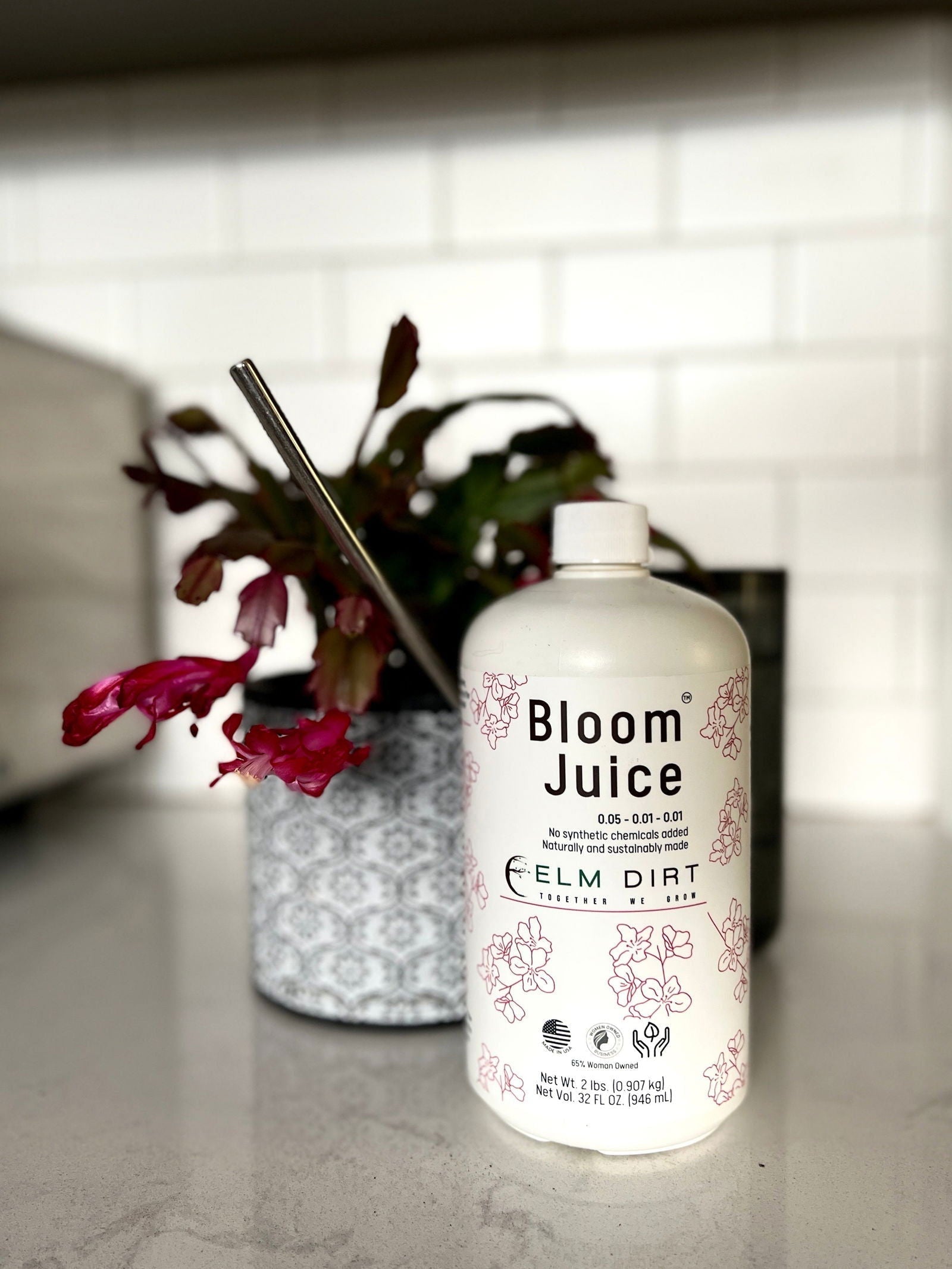 Elm Dirt Bloom Juice fertilizer bottle, 32 oz, natural plant nutrient for healthy flowering and vibrant growth.