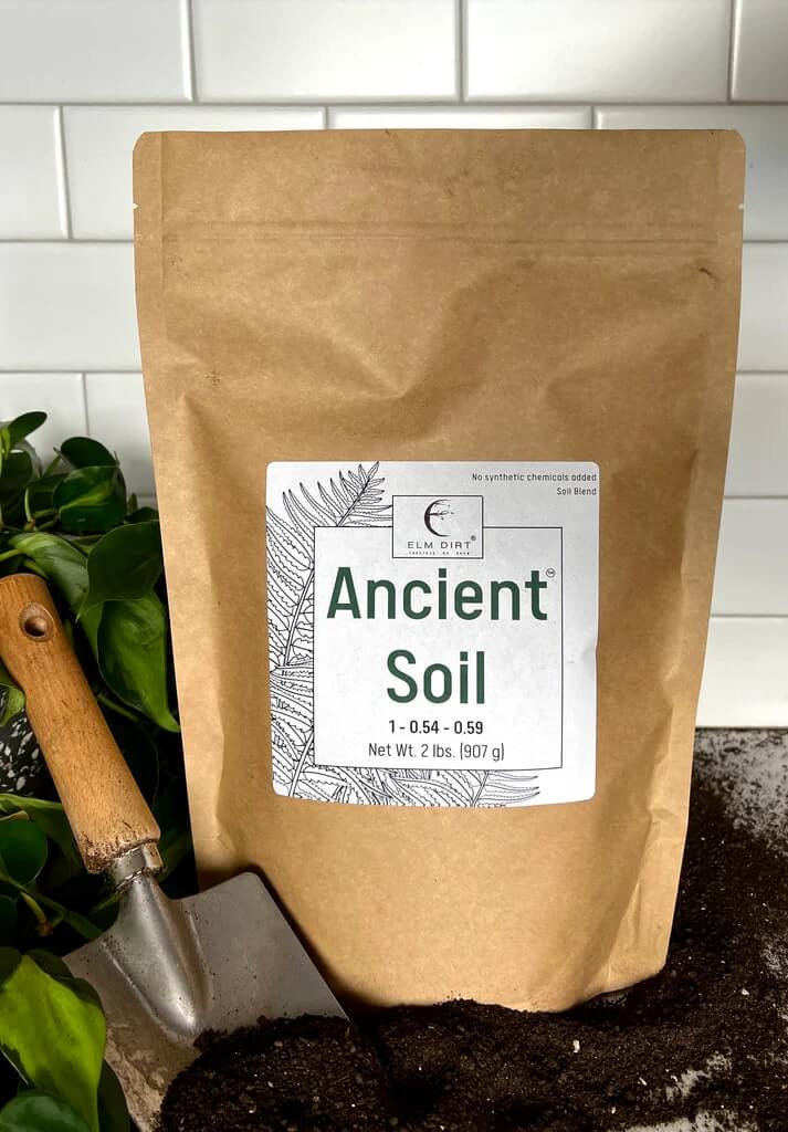 Elm Dirt Ancient Soil organic living soil for thriving plants, shown in a 2-pound bag with rich, dark soil visible.