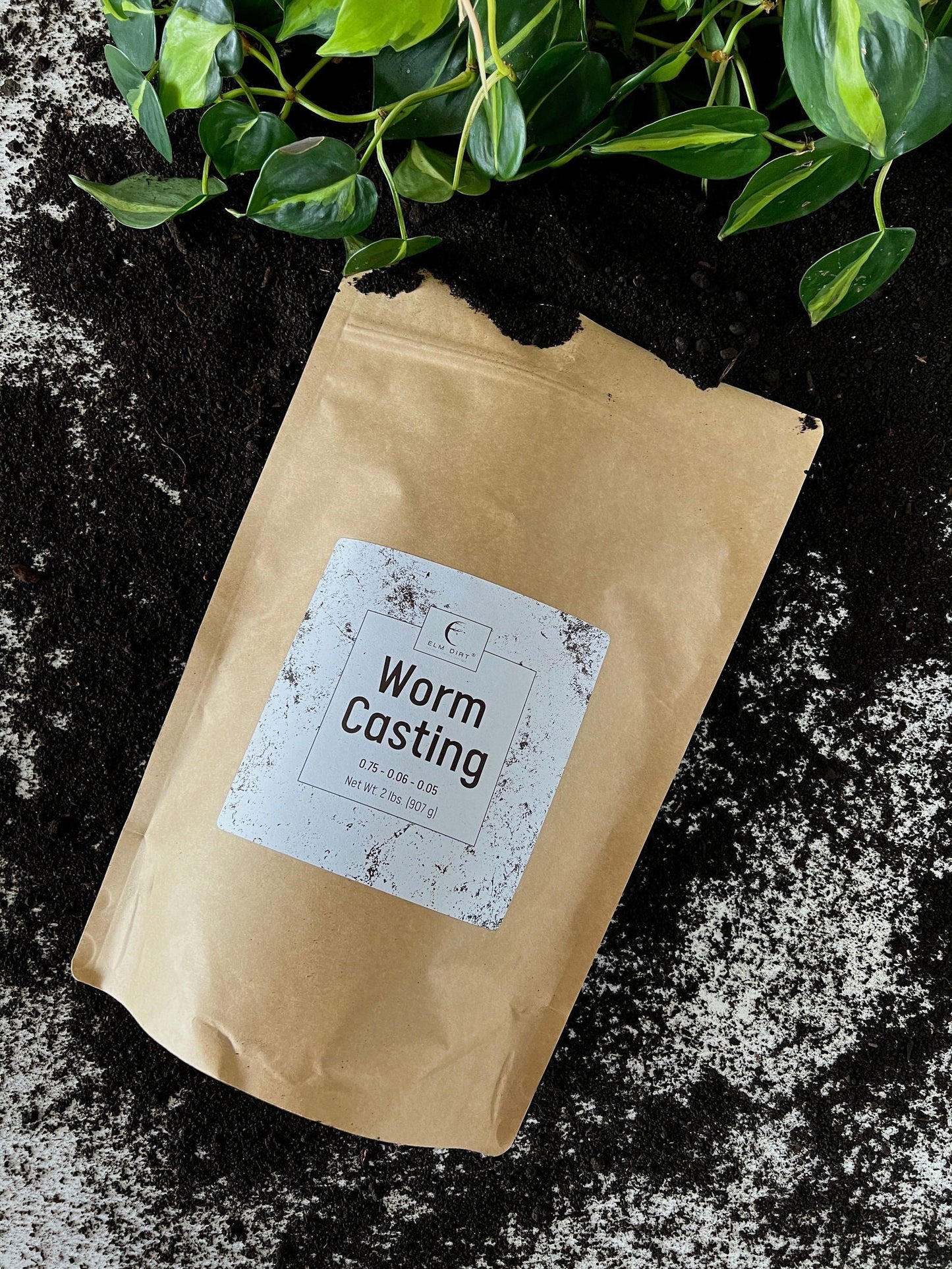 Two pounds of Elm Dirt worm castings, rich organic soil amendment with dark, nutrient-packed worm castings in a clear bag.