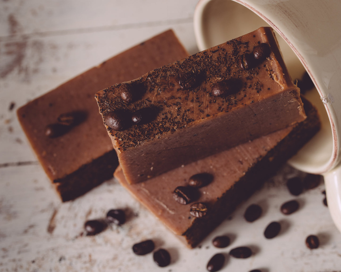 Organic handmade coffee soap by Sweet Harvest Farms featuring a bar with textured surface and rich brown color for exfoliation.