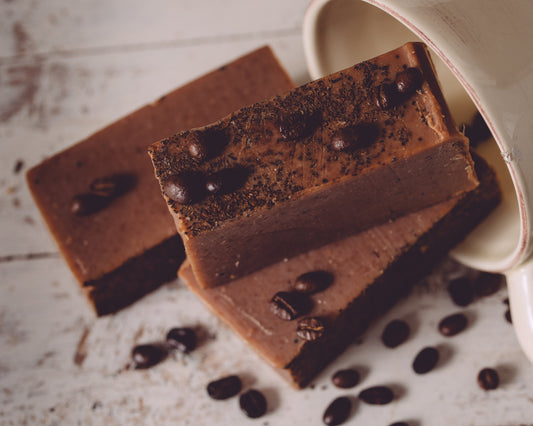 Organic handmade coffee soap by Sweet Harvest Farms featuring a bar with textured surface and rich brown color for exfoliation.