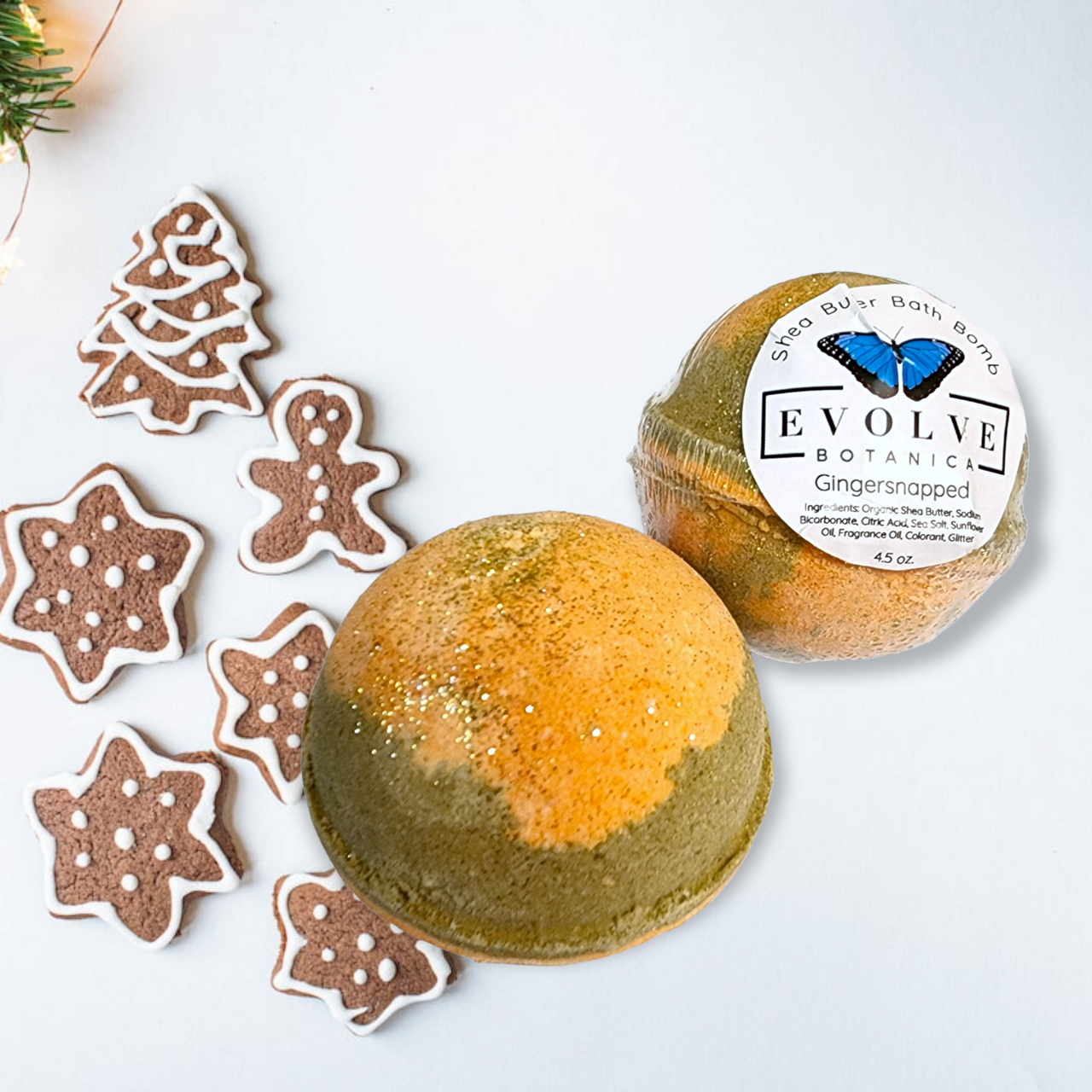 Evolve Botanica Gingersnapped bath bomb with festive holiday packaging, featuring a warm gingerbread scent and holiday-themed design.