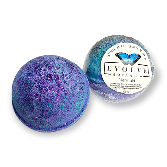 Evolve Botanica Mermaid Bath Bomb with colorful swirls and shimmering effects, designed for relaxing bath experience.