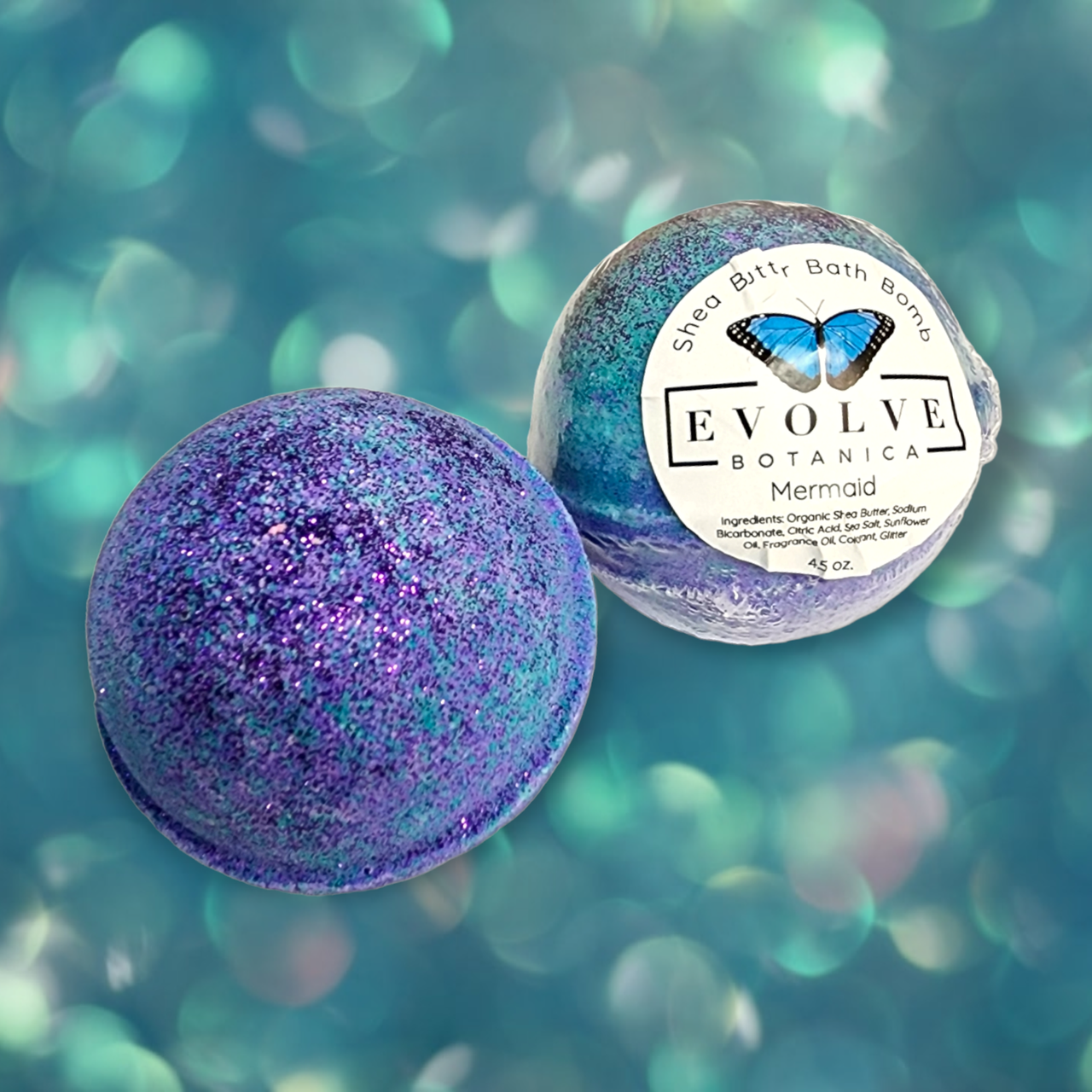 Evolve Botanica Mermaid Bath Bomb with vibrant colors and seashell design, floating in a bathtub for a relaxing bath experience.