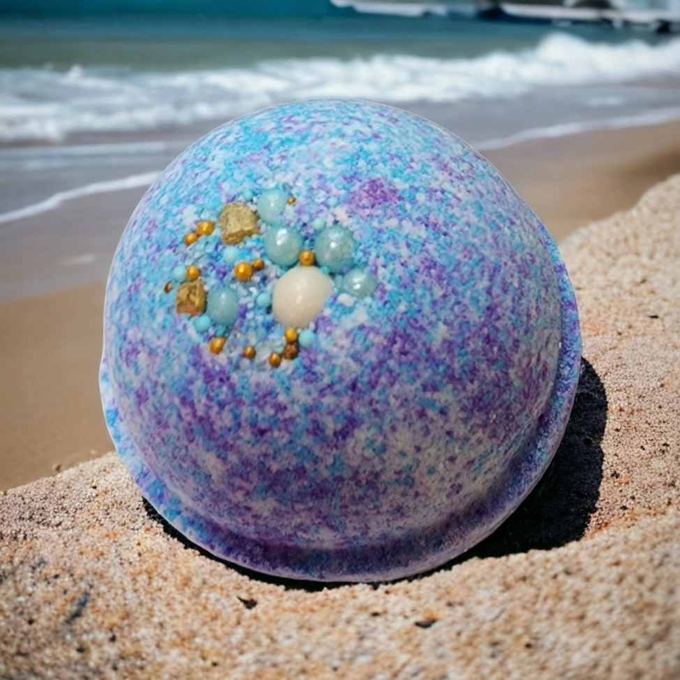 Evolve Botanica Sea Glass Bath Bomb with blue and green swirls, relaxing and aromatic, in a clear plastic wrapper.