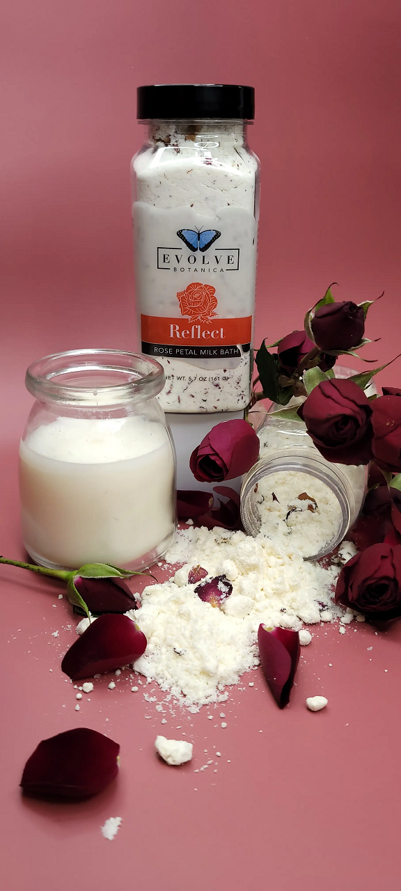 Evolve Botanica Reflect Milk Bath with Rose scent, showing a soothing pink powder in a clear jar with rose petals.
