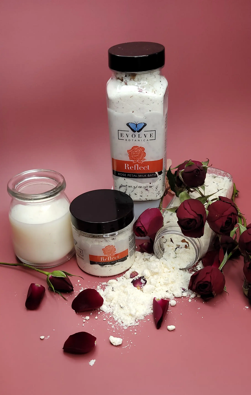 Evolve Botanica Reflect Milk Bath with Rose, showing a luxurious pink milk bath powder in a white jar with rose accents.