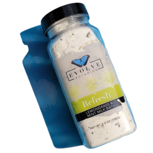 Evolve Botanica Milk Bath Refresh with lemongrass and mint, featuring a soothing presentation of the bath product in a natural setting.
