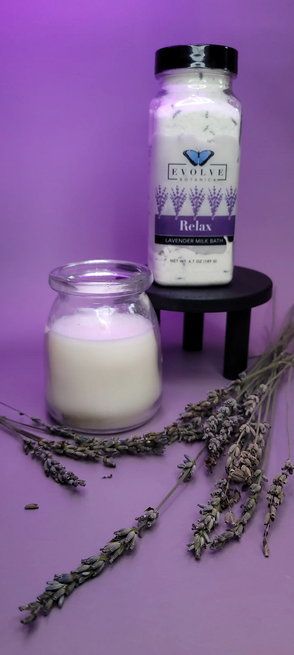 Evolve Botanica Relax Lavender Milk Bath powder in a jar, with dried lavender flowers and soothing packaging visible.