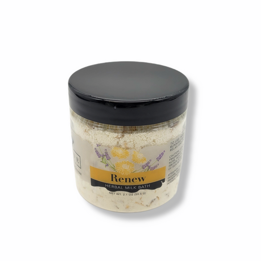 Mini herbal milk bath by Evolve Botanica with dried herbs and natural ingredients in a glass jar for relaxing bath rituals.