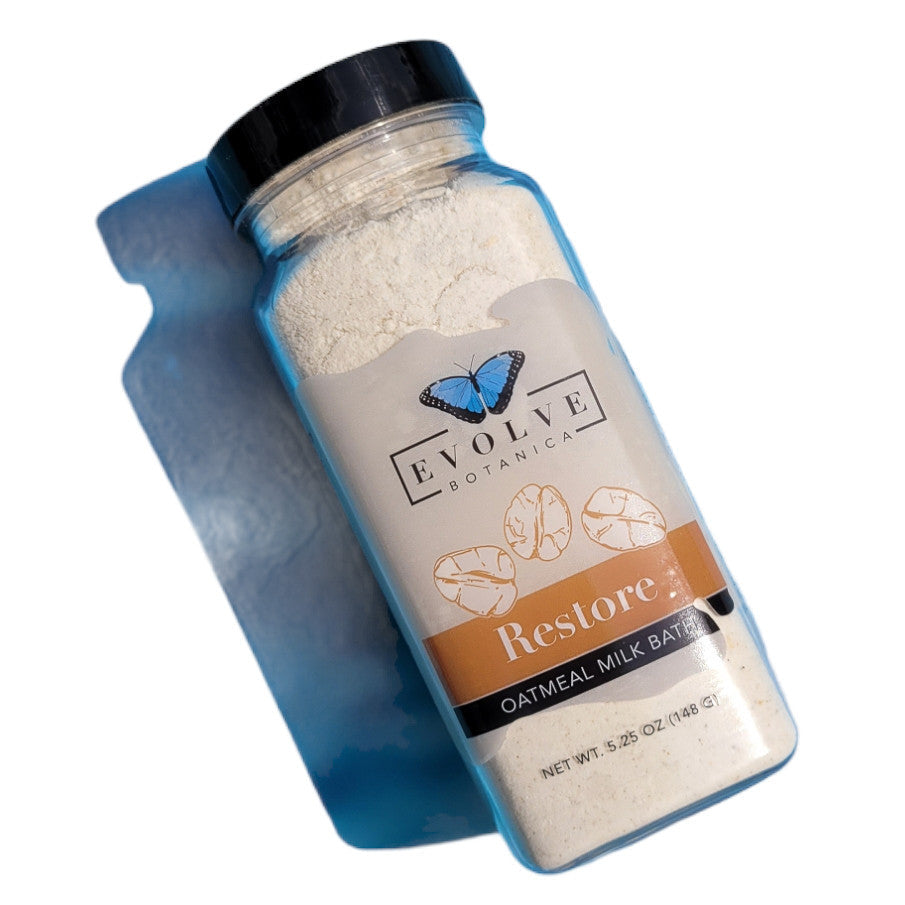 Evolve Botanica Milk Bath Restore with oatmeal in a white bowl, creamy texture, and soothing natural ingredients.